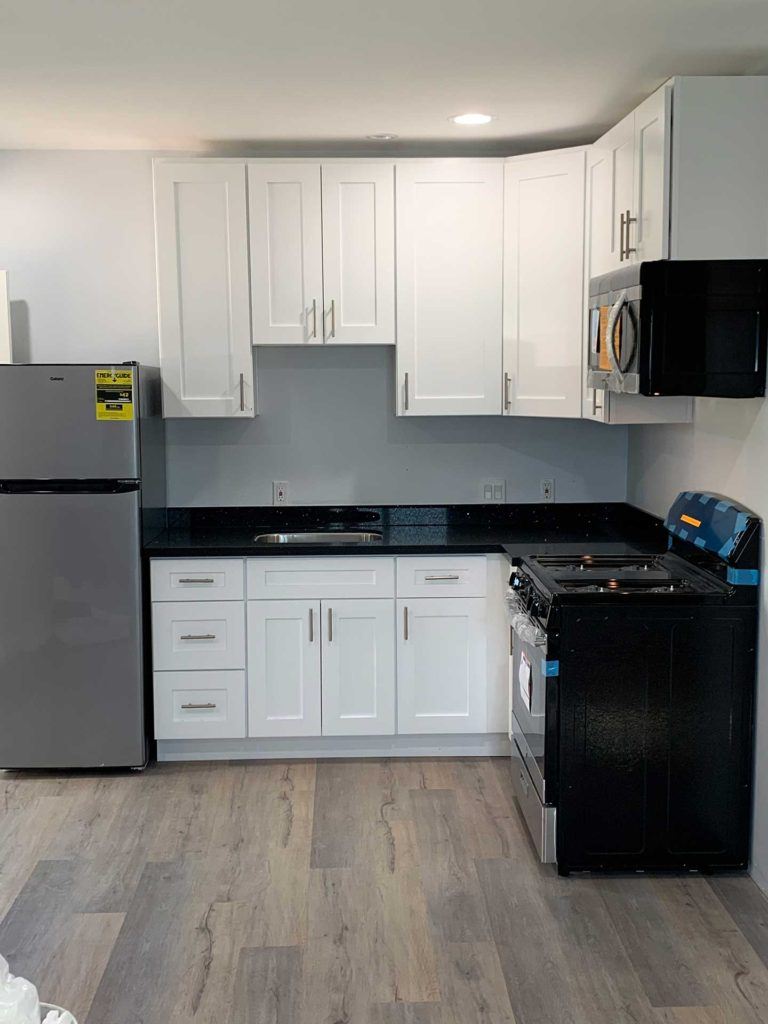 kitchen white cabinetry with new fridge oven and stove