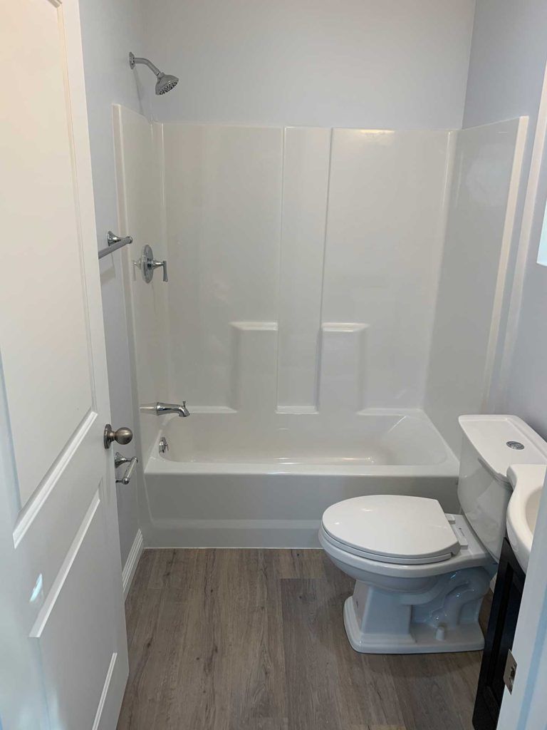 bathroom with toilet and small shower