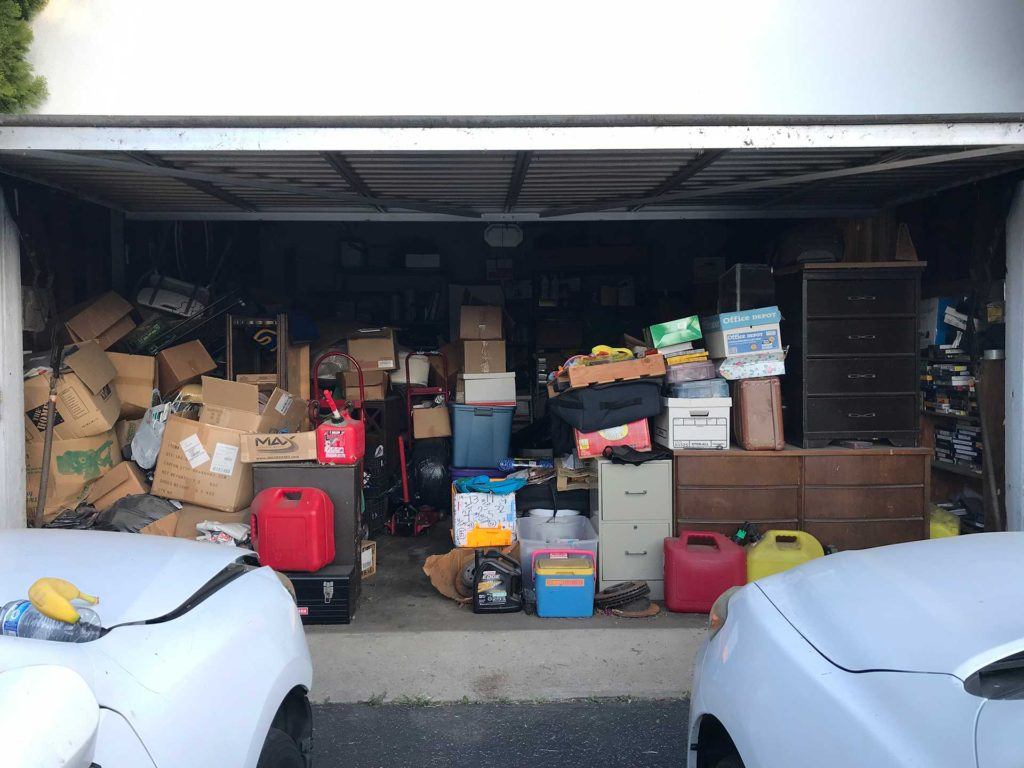 open garage filled with boxes and furniture