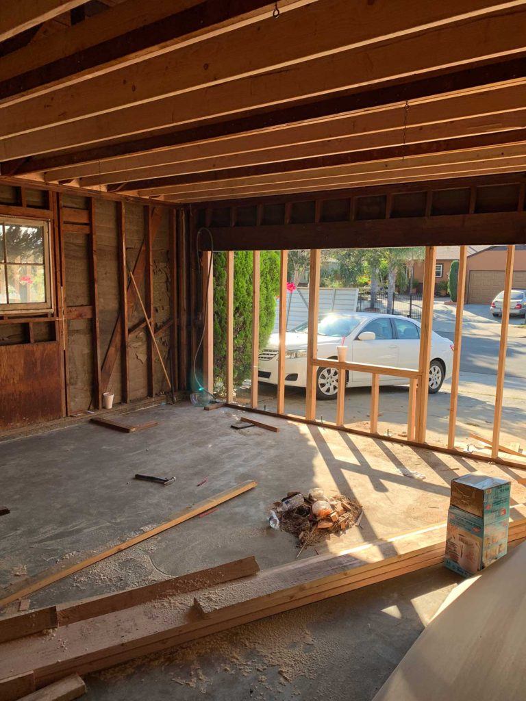 interior of garage during conversion process with wood framing visible