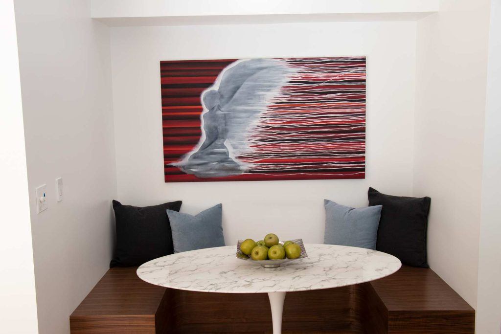 dining area with angel statue artwork on the wall