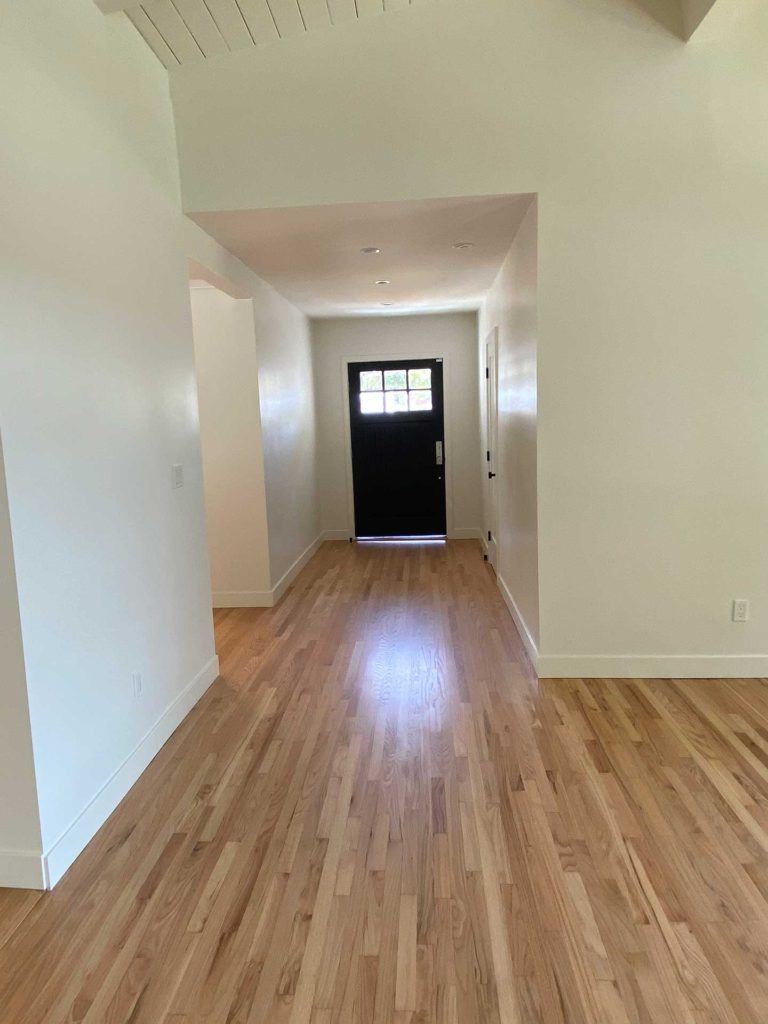 hallway of home with hardwood floors