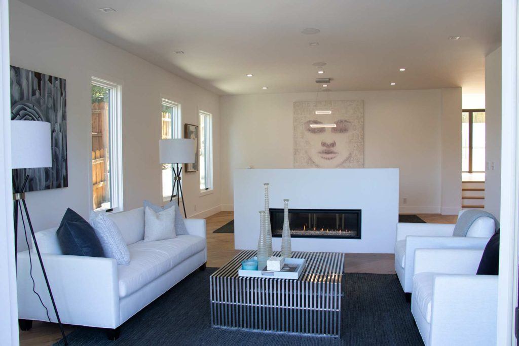 living room with white couch chairs and fireplace