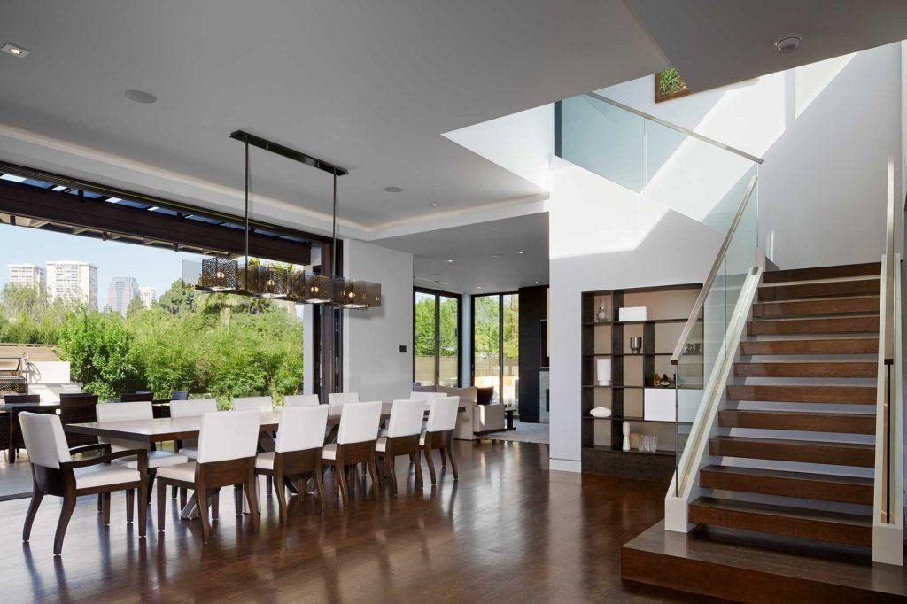 dining room table in large room with staircase on the right