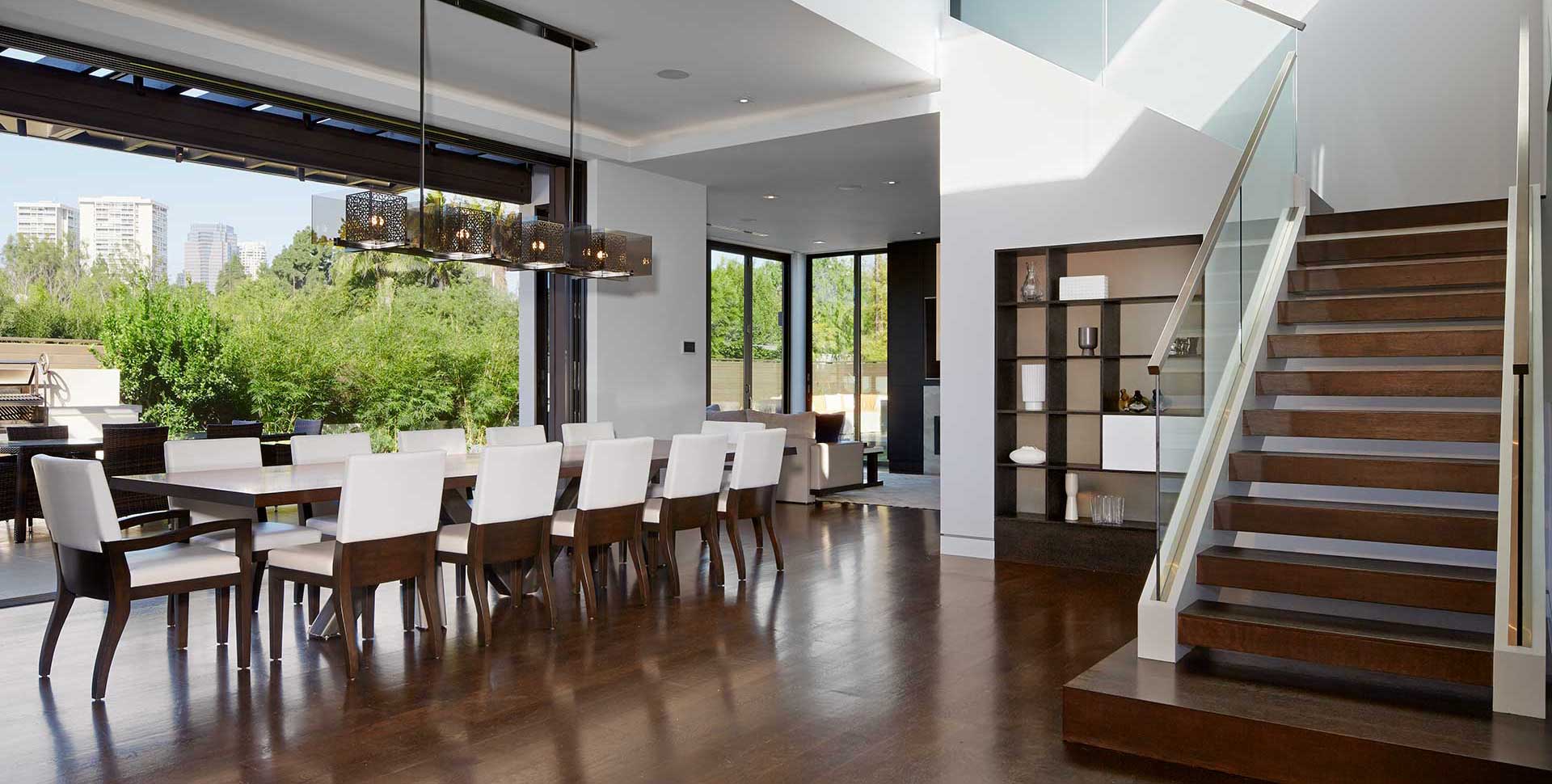 dining room table in large room with staircase on the right