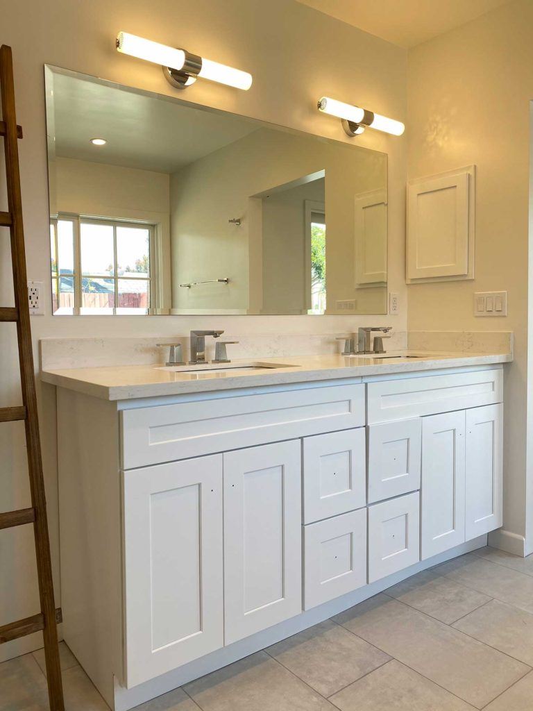 white vanity with rectangular mirror