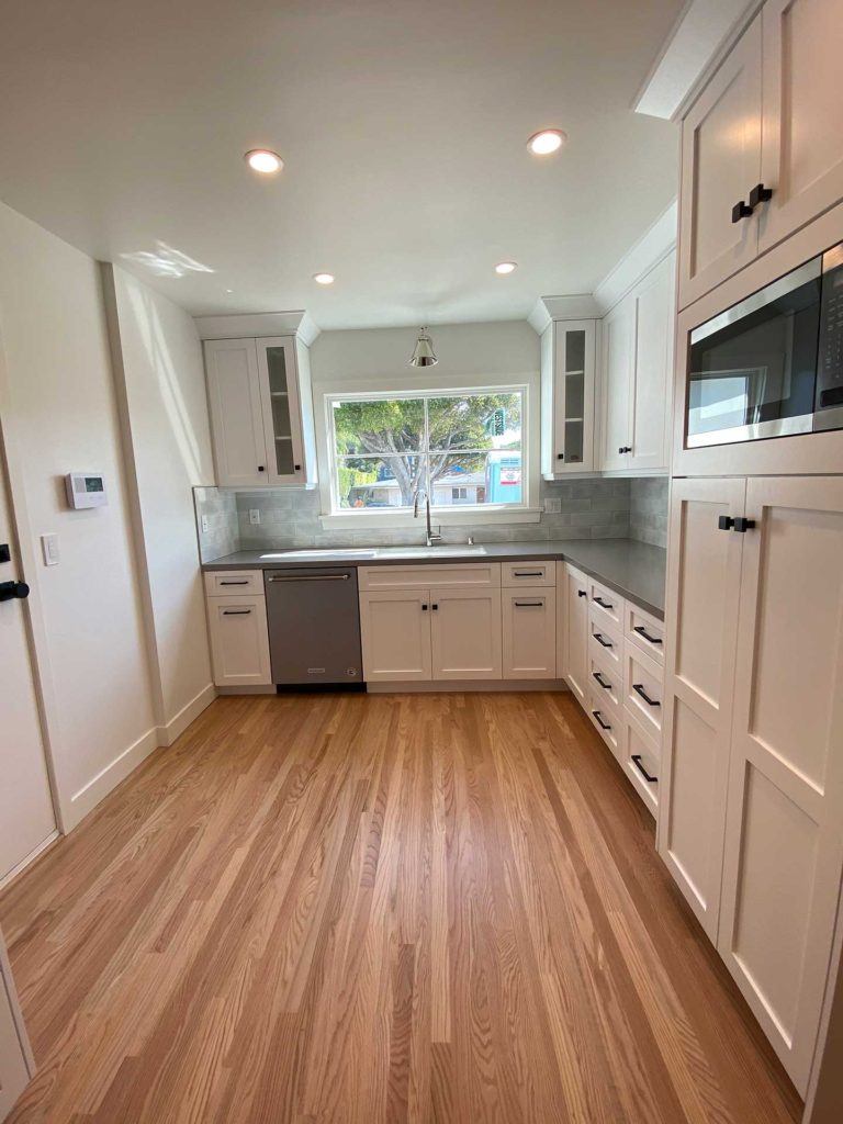 kitchen with hardwood floor and white cabinetry