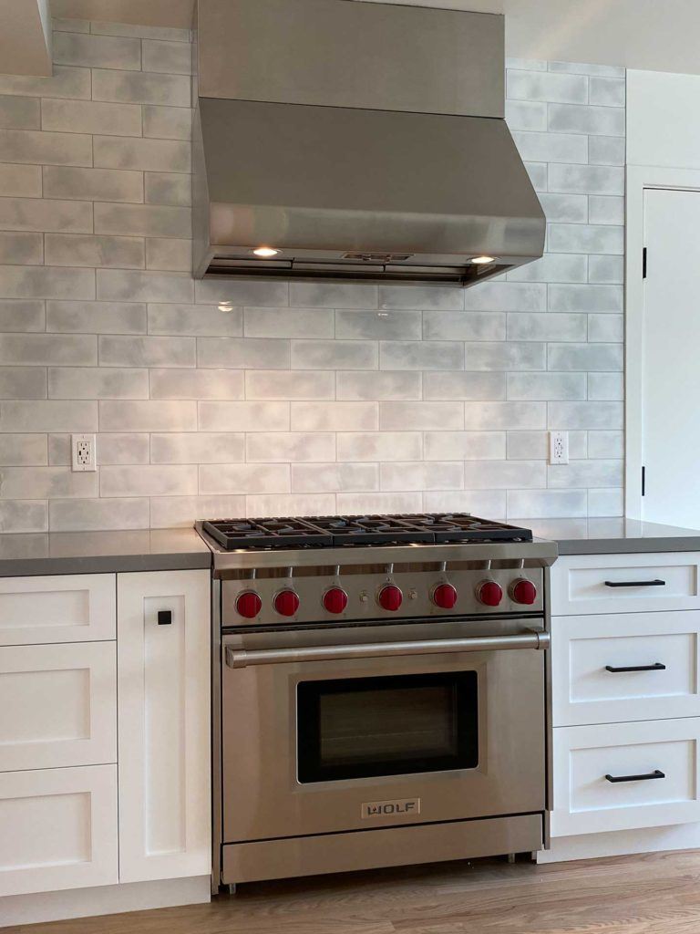 stainless steel stove and oven between white cabinetry