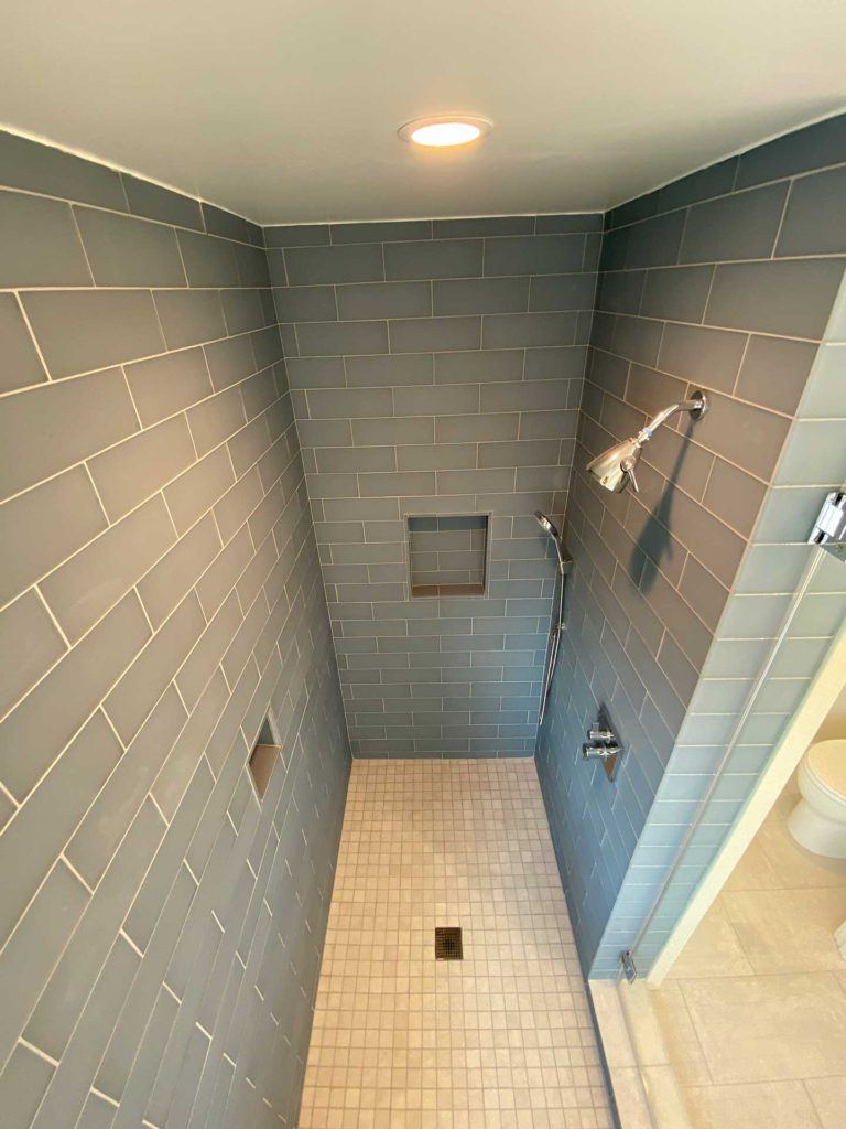 aerial view of shower with rectangular grey blue tiles